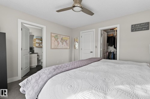 This well-appointed room features light-colored walls and a ceiling fan, providing a comfortable atmosphere - 9084 Rosenthal Link, Edmonton, AB - Indoor Photo Showing Bedroom