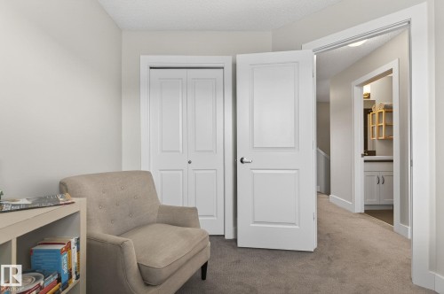 This room features neutral-toned carpeting and light-colored walls - 9084 Rosenthal Link, Edmonton, AB - Indoor