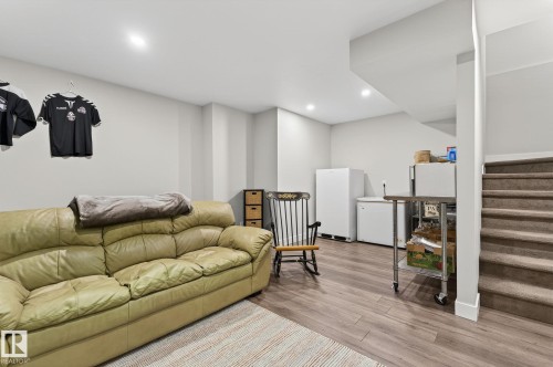 This versatile space features light gray walls, recessed lighting, and wood-style flooring - 9084 Rosenthal Link, Edmonton, AB - Indoor