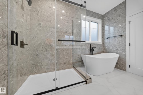 Bathroom featuring a glass-enclosed shower with dark fixtures and a freestanding white bathtub - 6117 Crawford Drive, Edmonton, AB 