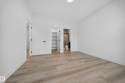 This room features light-toned flooring, white walls, and white trim - 6117 Crawford Drive, Edmonton, AB 