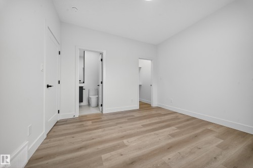 This room features light-toned flooring, white walls, and white trim - 6117 Crawford Drive, Edmonton, AB 