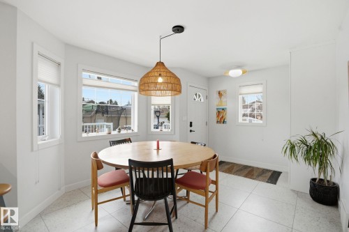 Bright room with white walls, tiled flooring, and multiple windows providing natural light - 7235 112 Street, Edmonton, AB - Indoor Photo Showing Dining Room