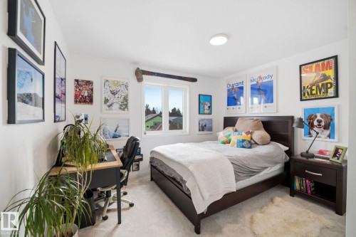 This room features a window providing natural light, light-colored carpet, and white walls - 7235 112 Street, Edmonton, AB - Indoor Photo Showing Bedroom