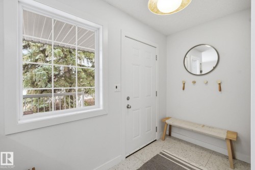 Bright entryway featuring a white paneled door, a gridded window, and overhead lighting - 7235 112 Street, Edmonton, AB - Indoor Photo Showing Other Room