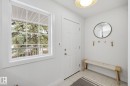 Bright entryway featuring a white paneled door, a gridded window, and overhead lighting - 7235 112 Street, Edmonton, AB  - Indoor Photo Showing Other Room 