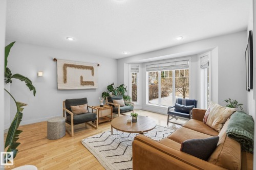 Living area with light hardwood flooring, a large bay window, and recessed lighting - 7235 112 Street, Edmonton, AB - Indoor Photo Showing Living Room