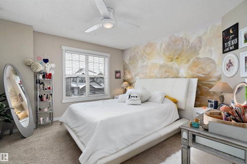 The bedroom features a window with blinds, a ceiling fan with integrated lighting, and carpeted flooring - 2914 18A Avenue, Edmonton, AB - Indoor Photo Showing Bedroom