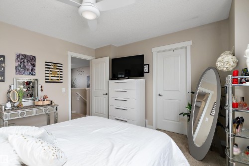 This room features a ceiling fan with integrated lighting, neutral wall colors, and a white six-drawer dresser - 2914 18A Avenue, Edmonton, AB - Indoor Photo Showing Bedroom