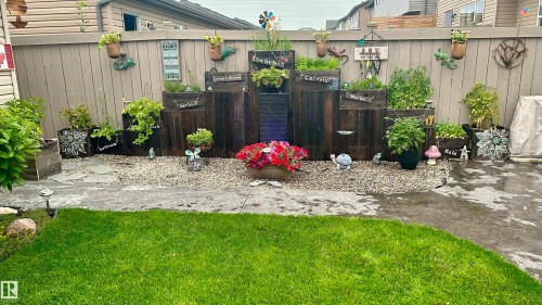 The property features a well-maintained yard with a lawn and a decorative gravel area - 2914 18A Avenue, Edmonton, AB - Outdoor