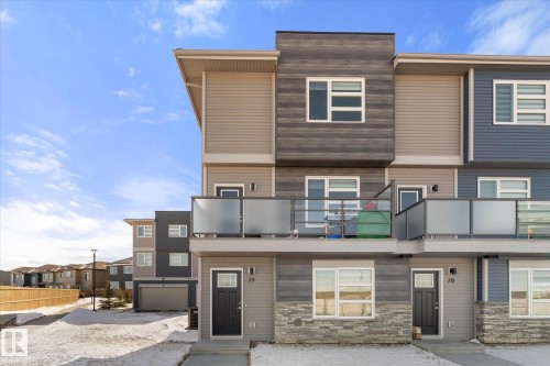 The property features a modern exterior with varied siding textures and colors, including stone accents - 79 17635 58 Street, Edmonton, AB - Outdoor With Balcony