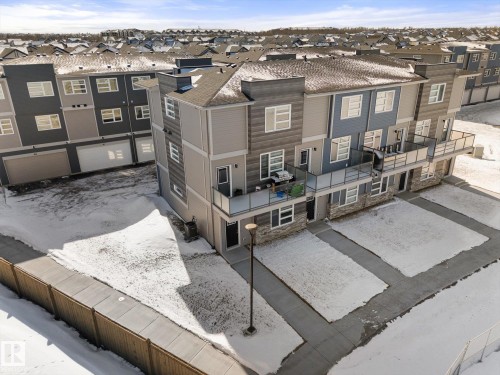 The property features a multi-story exterior with balconies and ground-level patios - 79 17635 58 Street, Edmonton, AB - Outdoor