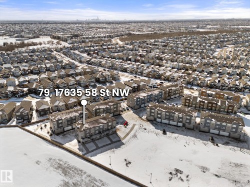 Aerial view showcasing the property within a residential community, featuring a clear sky and snow-covered ground - 79 17635 58 Street, Edmonton, AB - Outdoor With View