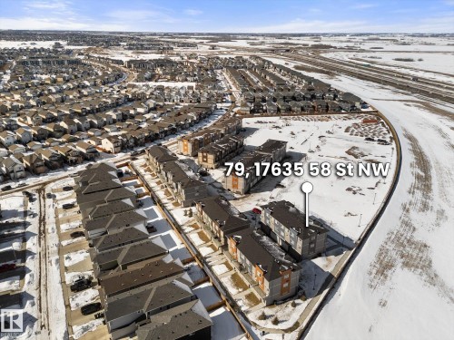 Aerial view showcasing the property within a structured residential area, featuring a clear main road visible in the background - 79 17635 58 Street, Edmonton, AB - Outdoor With View