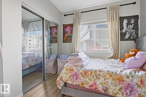 Room with light-colored walls, a window with blinds, and mirrored closet doors - 155 1818 Rutherford Road, Edmonton, AB - Indoor Photo Showing Bedroom