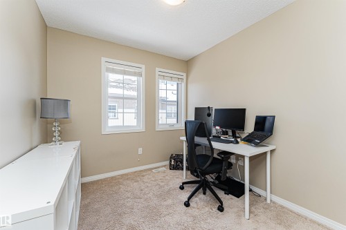 This room features two windows and light-colored carpeting - 31 4029 Orchards Drive, Edmonton, autreother - Indoor Photo Showing Office