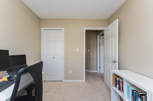 This room features a neutral color palette, complementing the carpeted floors and white trim - 31 4029 Orchards Drive, Edmonton, autreother - Indoor Photo Showing Office