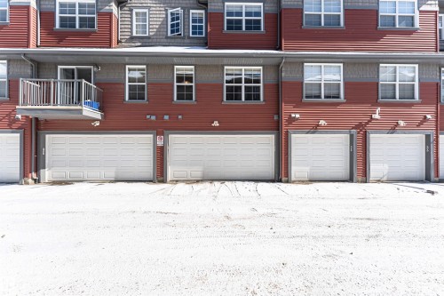 The property features a red facade with gray trim and white-framed windows - 31 4029 Orchards Drive, Edmonton, autreother - Outdoor