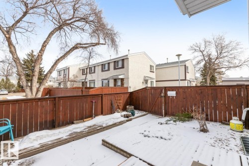 The property features a fenced yard with a gate, offering privacy - 242 Primrose Gardens, Edmonton, AB - Outdoor