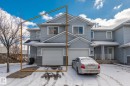 The property features light blue siding, an attached garage, and a covered front entry - 92 4350 23 Street Nw, Edmonton, AB  - Outdoor With Facade 