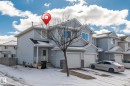 The property features light blue siding, a covered entryway, and two attached garage spaces - 92 4350 23 Street Nw, Edmonton, AB  - Outdoor With Facade 