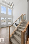 The property features a grand two-story living area with large windows providing ample natural light - 