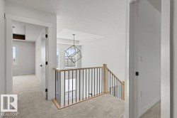 The property features light-colored carpeting, white walls, and white trim throughout - 