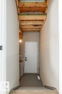 Interior view of a staircase leading down to a landing with a white door - 