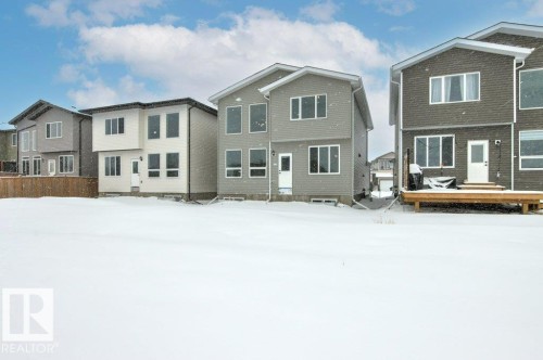 The property features a spacious backyard with a wooden deck, providing an opportunity for outdoor enjoyment - 5018 53 Avenue, Calmar, AB - Outdoor With Facade