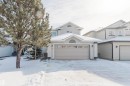 The property features an attached garage with an arched window detail and sconce lighting - 1135 112 Street, Edmonton, AB  - Outdoor With Facade 