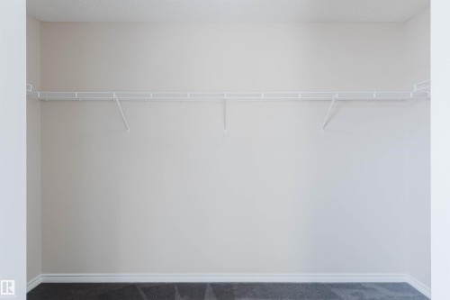 This space features a wall-mounted wire shelving system, providing practical storage - 1135 112 Street, Edmonton, AB - Indoor With Storage