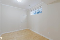 This room features light-colored walls, light-toned wood flooring, and a window providing natural light - 