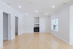 Bright room featuring hardwood floors, recessed lighting, and a built-in fireplace - 