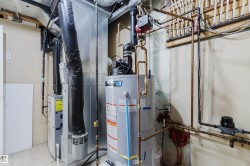 Utility area featuring a water heater, furnace, and visible copper piping - 