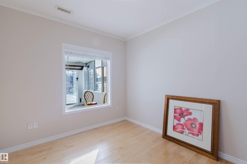 This room features light-colored walls and light-toned hardwood flooring - 1135 112 Street, Edmonton, AB - Indoor Photo Showing Other Room