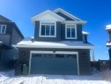 The property features a blue exterior with white trim and a prominent front-facing garage - 5333 21A Avenue, Edmonton, AB  - Outdoor 