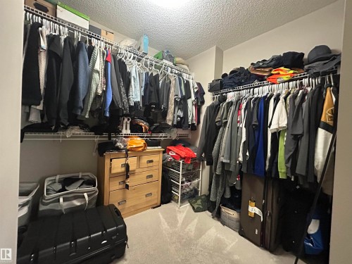 The property includes a walk-in closet featuring wire shelving and hanging rods - 5333 21A Avenue, Edmonton, AB - Indoor With Storage