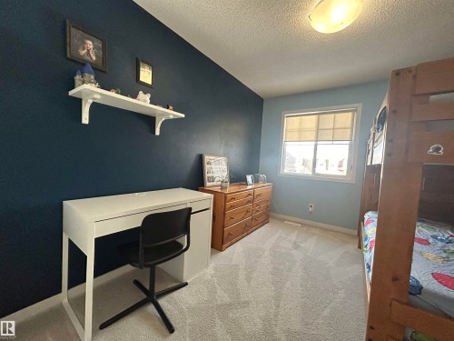The room features two-toned walls, a window with blinds, and carpeted flooring - 5333 21A Avenue, Edmonton, AB - Indoor Photo Showing Other Room
