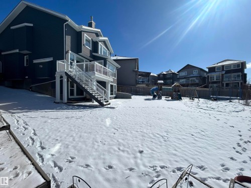 The property features a dark-toned exterior and a spacious backyard - 5333 21A Avenue, Edmonton, AB - Outdoor