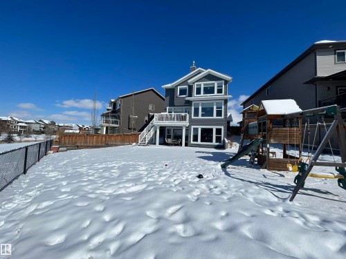 The property features a three-story exterior with a deck on the second level and a walk-out patio on the first level - 5333 21A Avenue, Edmonton, AB - Outdoor