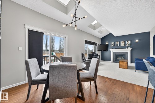 112 Windrose Drive, Leduc, AB - Indoor Photo Showing Dining Room With Fireplace