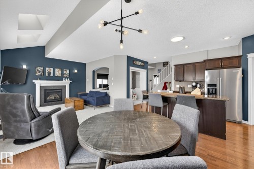 112 Windrose Drive, Leduc, AB - Indoor Photo Showing Dining Room With Fireplace
