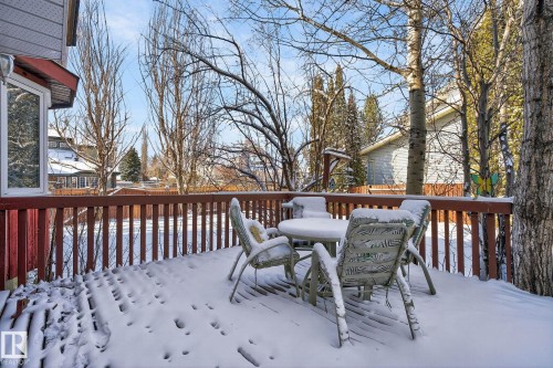 The property features a wooden deck with a matching wooden railing, providing an outdoor space - 5604 174 Street, Edmonton, AB - Outdoor