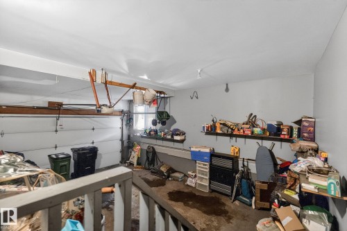 The property features an attached garage with a white overhead door and light-colored walls - 5604 174 Street, Edmonton, AB - Indoor Photo Showing Garage