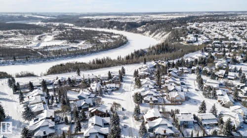 Aerial view of a residential area featuring numerous properties with snow-covered rooftops and surrounding trees - 5604 174 Street, Edmonton, AB - Outdoor With View