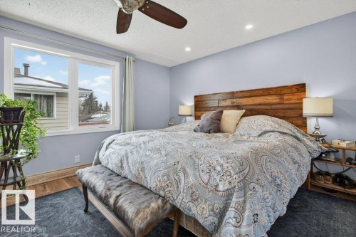 Spacious bedroom featuring light blue walls, recessed lighting, and a ceiling fan - 2655 89 Street, Edmonton, AB - Indoor Photo Showing Bedroom