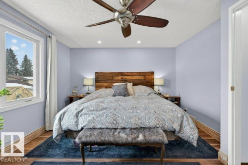 This room features light blue walls, hardwood flooring, and a ceiling fan - 2655 89 Street, Edmonton, AB - Indoor Photo Showing Bedroom