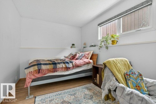 The room features hardwood style flooring and a window with a roller blind - 2655 89 Street, Edmonton, AB - Indoor Photo Showing Bedroom