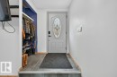 The property features an entryway with tiled flooring, a decorative front door with an oval glass insert, and a coat and shoe storage area - 2655 89 Street, Edmonton, AB  - Indoor Photo Showing Other Room 