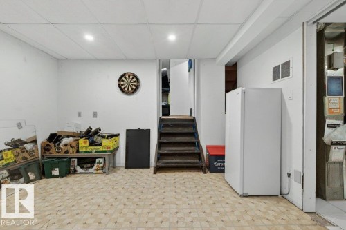 This area features white walls, a patterned floor, and recessed lighting - 2655 89 Street, Edmonton, AB - Indoor